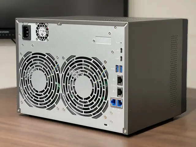 Rear of an 8-bay NAS storage unit showing cooling fans and network ports